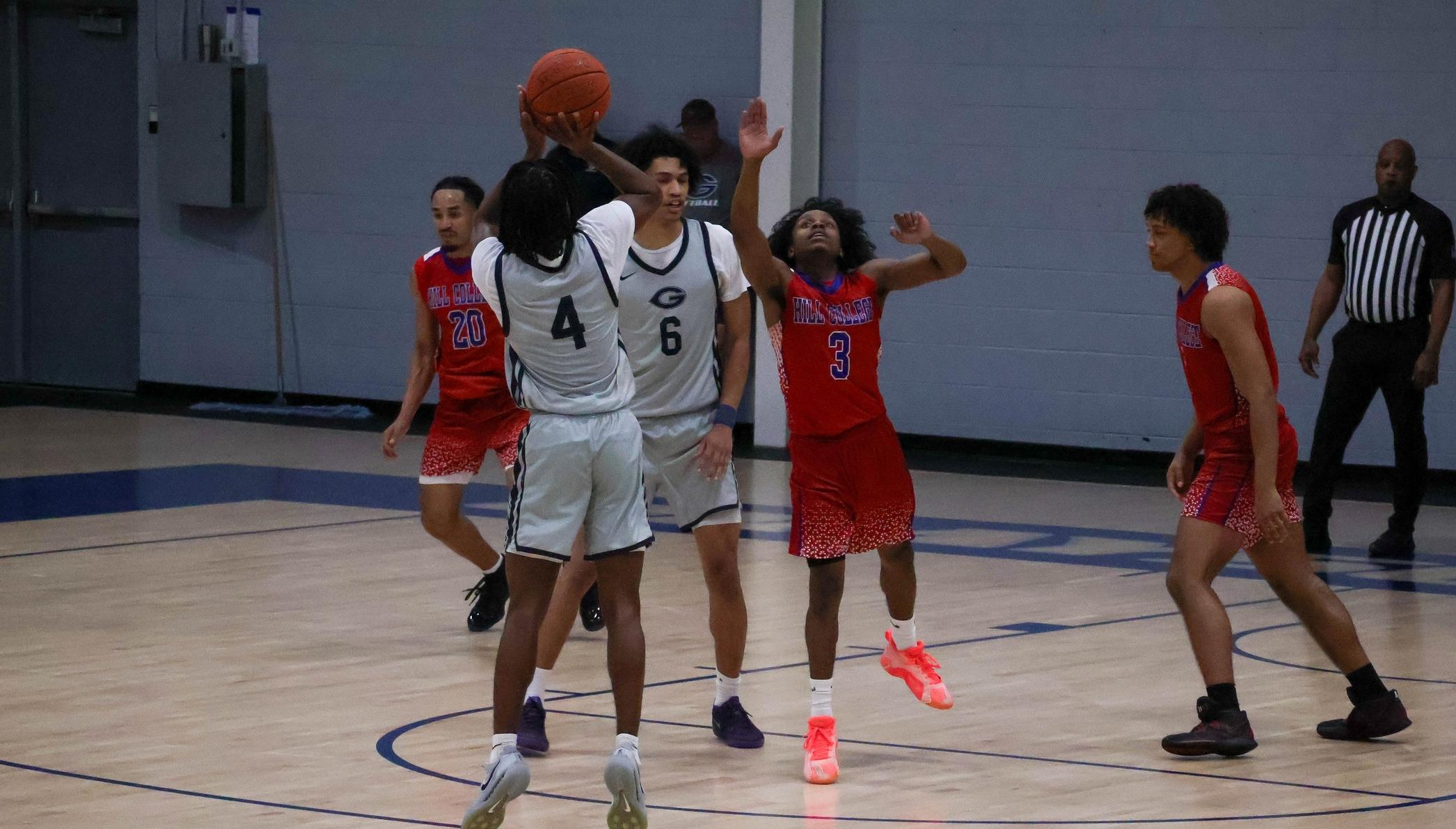 The Grayson Viking player in the gray jersey shoots the jump shot in a game. 